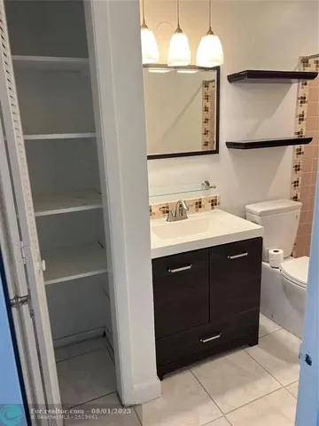 a bathroom with a sink vanity and a mirror