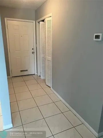 a view of a livingroom with an empty space and a window