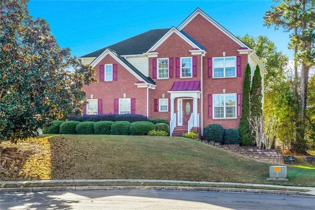 a front view of a house with a yard