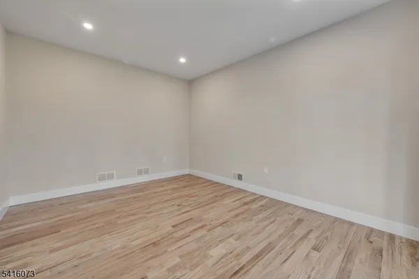 a view of room with wooden floor and fan
