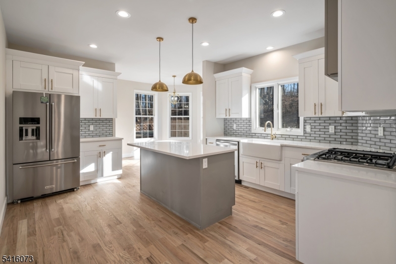 139 Flanders Netcong Road Flanders, NJ 07836 - Photo 16 of 40 a kitchen with a refrigerator a sink and wooden floor