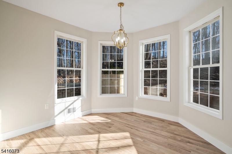 139 Flanders Netcong Road Flanders, NJ 07836 - Photo 18 of 40 a view of an empty room with windows and chandelier