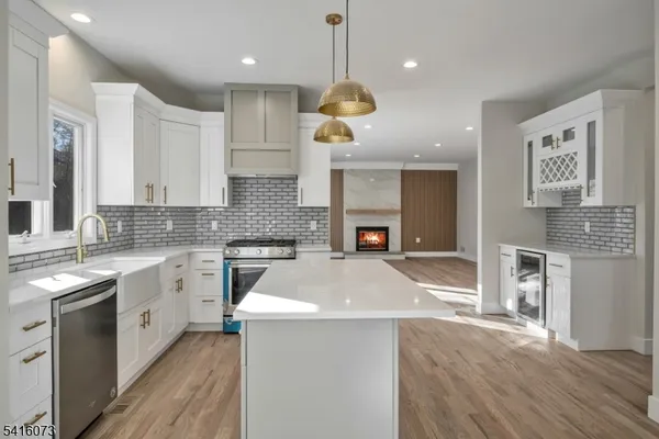 a kitchen with a sink appliances and cabinets