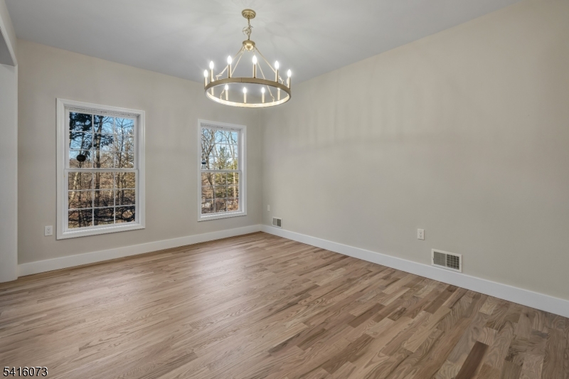 139 Flanders Netcong Road Flanders, NJ 07836 - Photo 22 of 40 a view of an empty room with wooden floor and a window