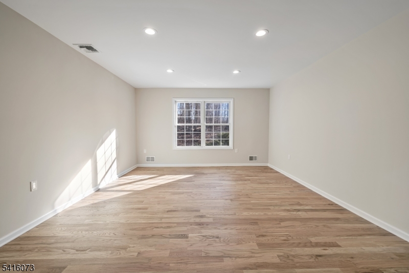 139 Flanders Netcong Road Flanders, NJ 07836 - Photo 26 of 40 a view of an empty room with wooden floor and a window