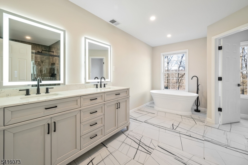 139 Flanders Netcong Road Flanders, NJ 07836 - Photo 29 of 40 a spacious bathroom with a double vanity sink a mirror and a bathtub