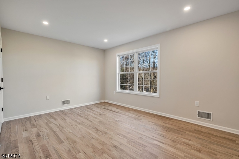 139 Flanders Netcong Road Flanders, NJ 07836 - Photo 31 of 40 an empty room with wooden floor and windows