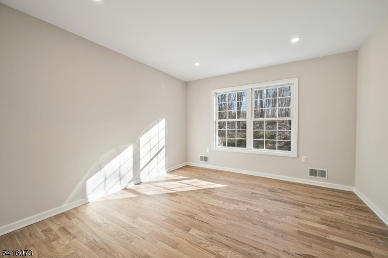 139 Flanders Netcong Road Flanders, NJ 07836 - Photo 32 of 40 a view of an empty room with wooden floor and a window