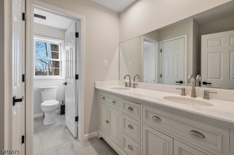 139 Flanders Netcong Road Flanders, NJ 07836 - Photo 34 of 40 a bathroom with a double vanity sink a mirror and a toilet