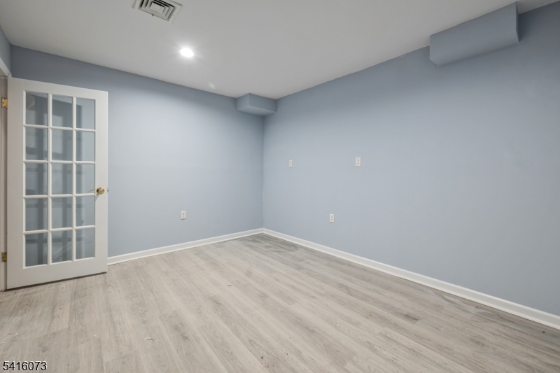 139 Flanders Netcong Road Flanders, NJ 07836 - Photo 37 of 40 an empty room with wooden floor and windows