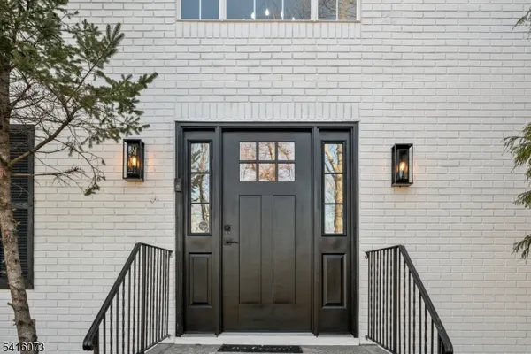 a front view of a house with iron gate