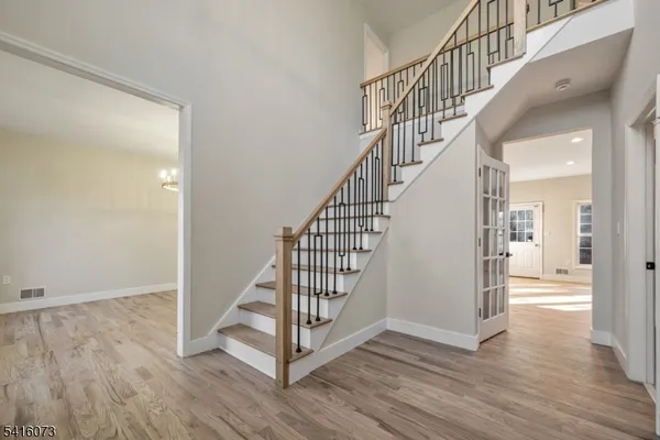 a view of entryway with wooden floor and stairs