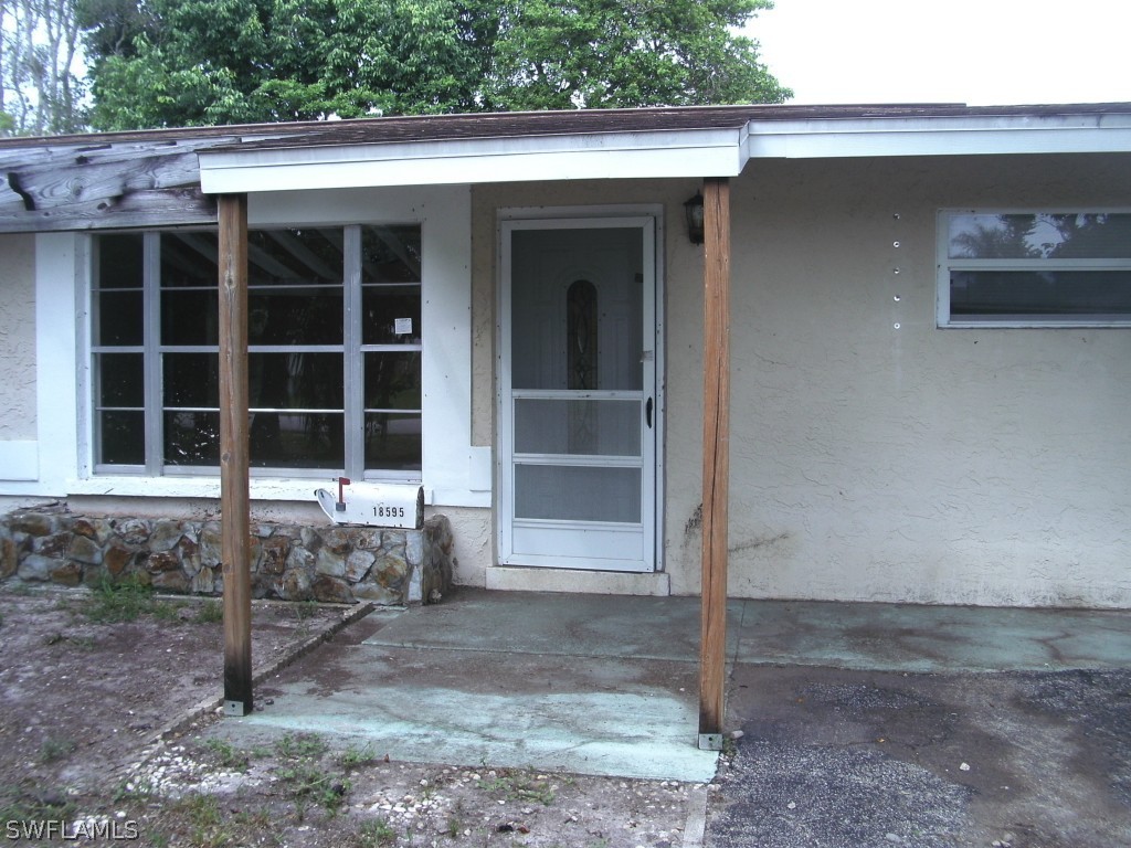 18595 Geranium Road Fort Myers, FL 33967 - Photo 3 of 15 a view of a house with a yard
