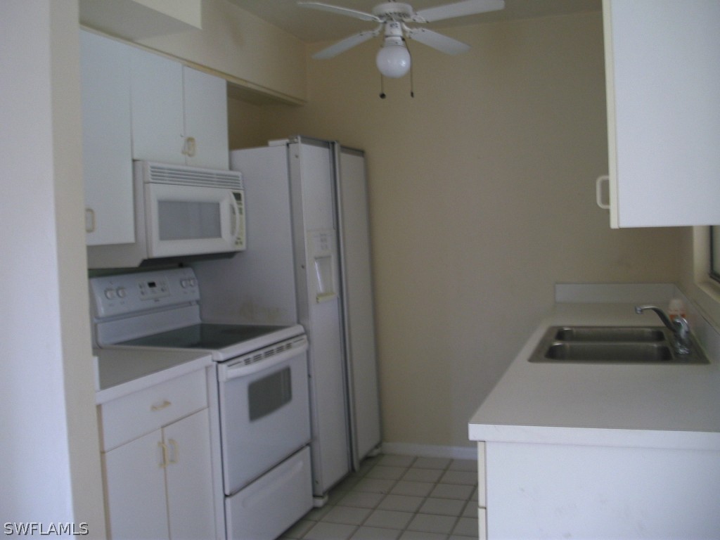 18595 Geranium Road Fort Myers, FL 33967 - Photo 6 of 15 a kitchen with a sink a stove and cabinets