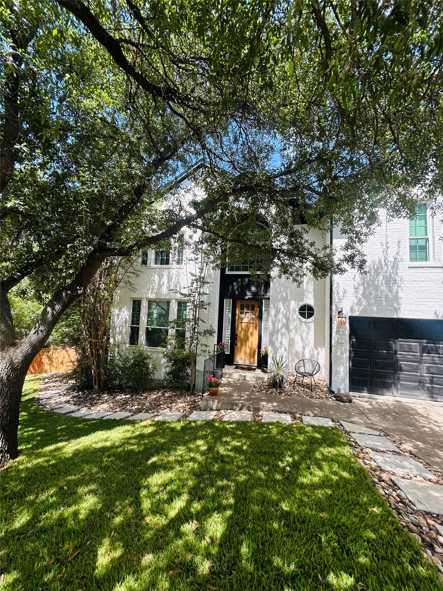 2204 Rimrock Drive Austin, TX 78738 - Photo 35 of 39 Mature trees shade a welcoming paved pathway leading to the handsome front entry.