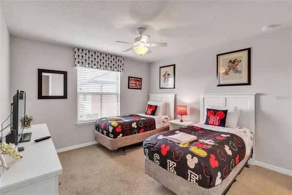 a bedroom with two beds and a couch