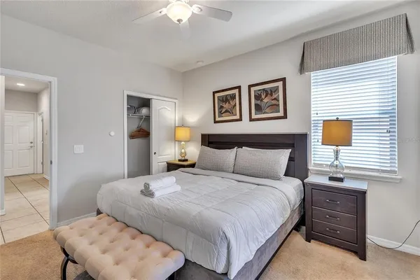 a bedroom with a bed and a lamp