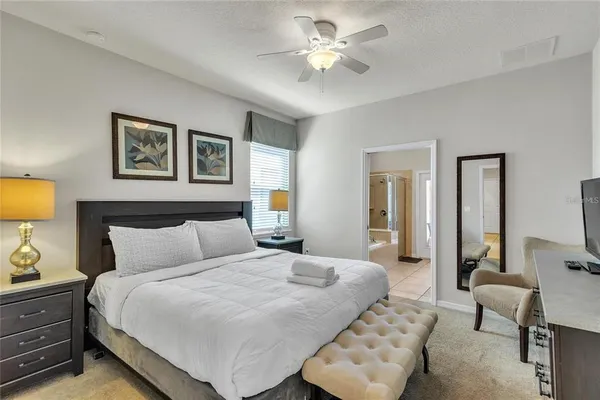 a bedroom with a bed and a chandelier