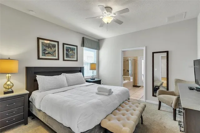 a bedroom with a bed and a chandelier