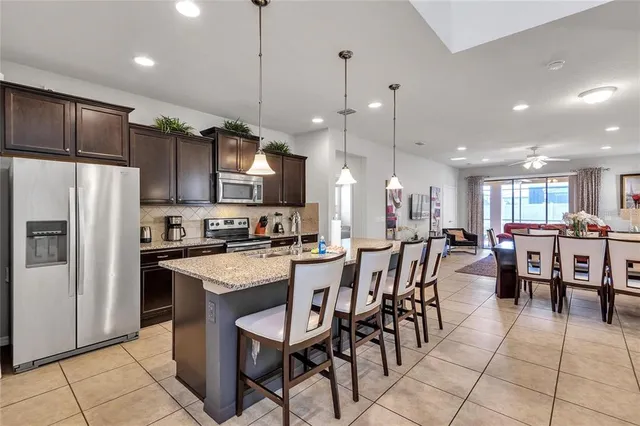 a large kitchen with a table and chairs