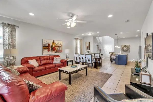 a living room with furniture and kitchen view
