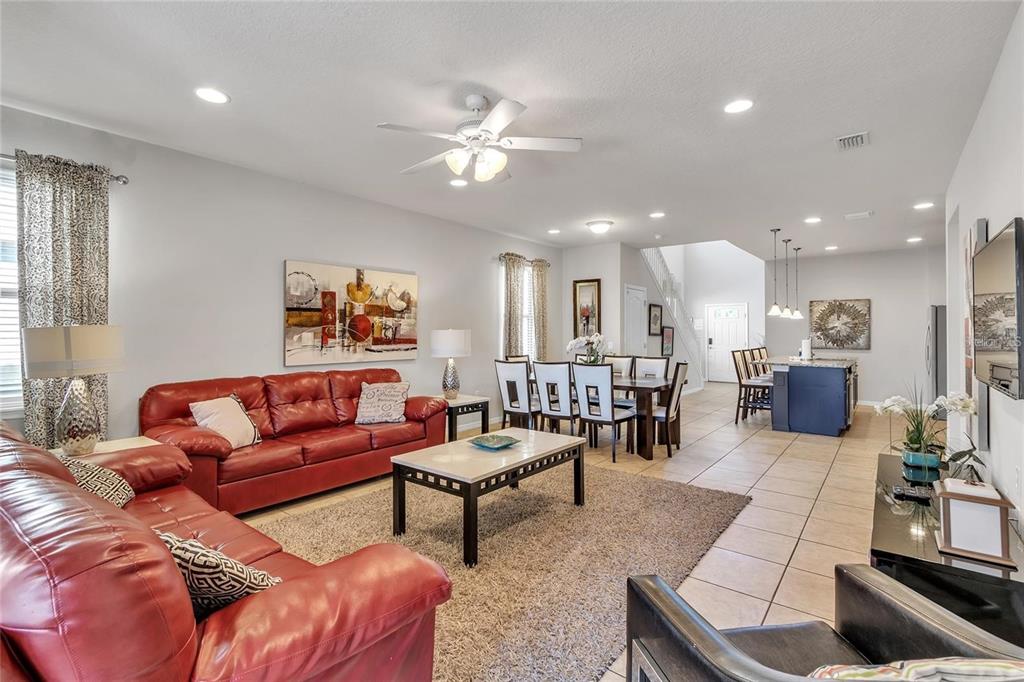8916 Rhodes Street Kissimmee, FL 34747 - Photo 4 of 34 a living room with furniture and kitchen view