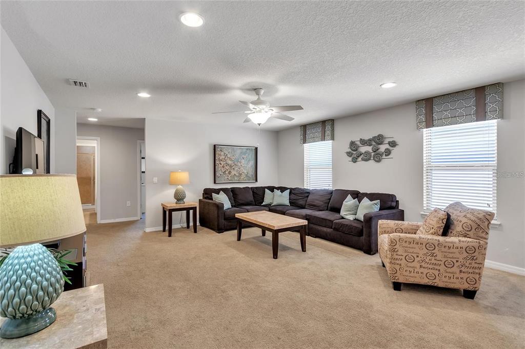 8916 Rhodes Street Kissimmee, FL 34747 - Photo 10 of 34 a living room with furniture and a ceiling fan
