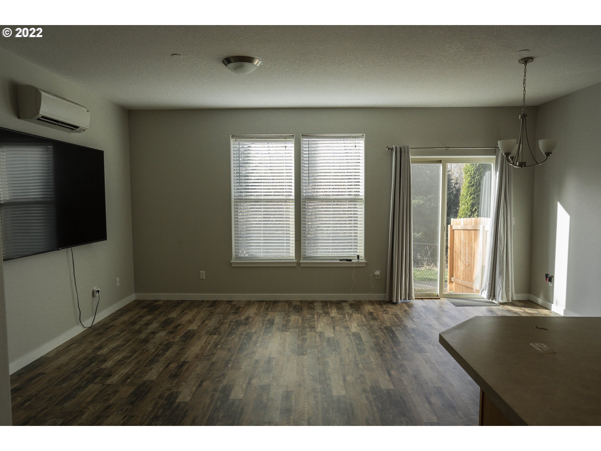 249 North 43rd Place Ridgefield, WA 98642 - Photo 13 of 32 a view of an empty room with a window and wooden floor