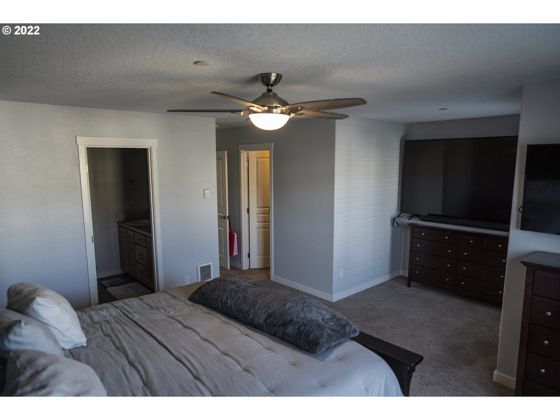 249 North 43rd Place Ridgefield, WA 98642 - Photo 23 of 32 a bedroom with a bed and a chandelier
