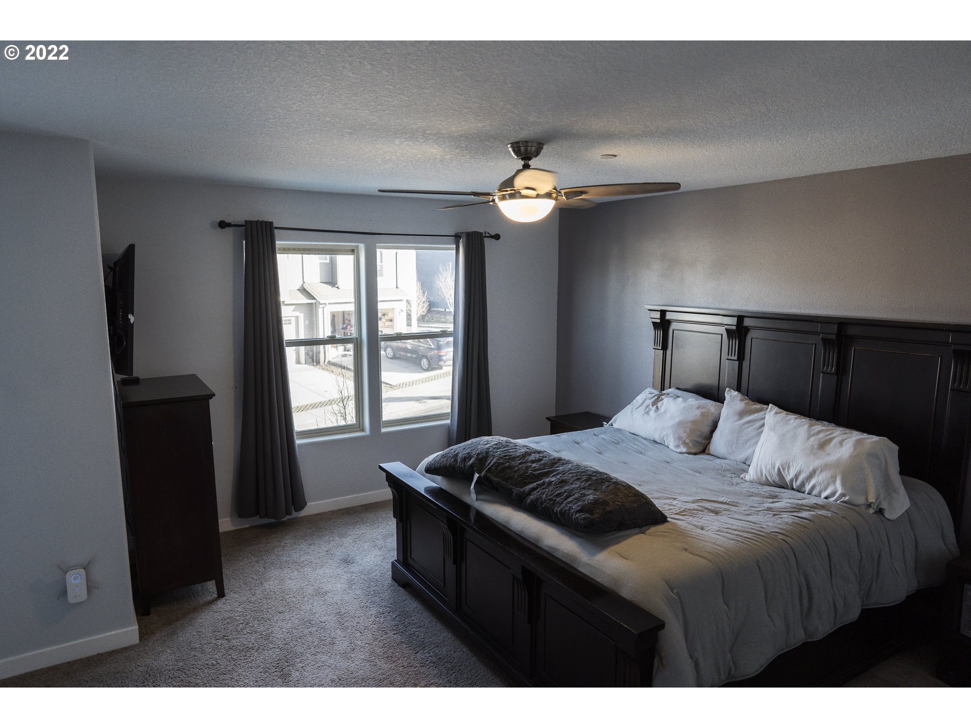 249 North 43rd Place Ridgefield, WA 98642 - Photo 27 of 32 a bedroom with a bed and a chandelier