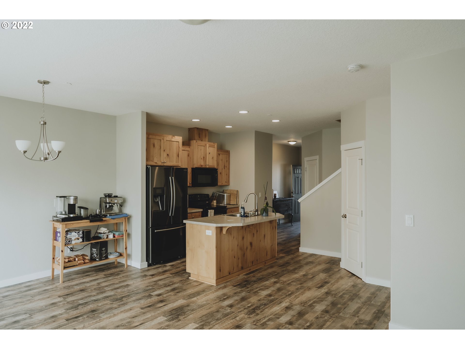 249 North 43rd Place Ridgefield, WA 98642 - Photo 5 of 32 a kitchen with a sink and a refrigerator