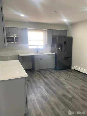 a kitchen with a stove a refrigerator and a sink