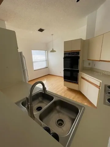 a kitchen with a sink and a stove top oven