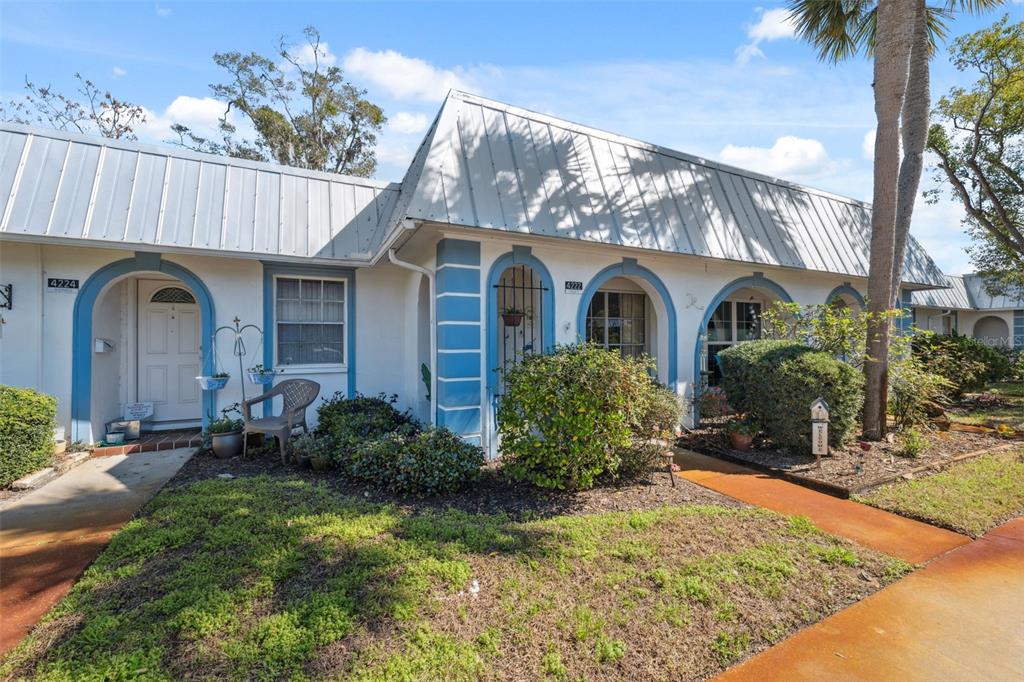4222 Richmere Drive, Unit 4222 New Port Richey, FL 34652 - Photo 11 of 36 a front view of a house with garden