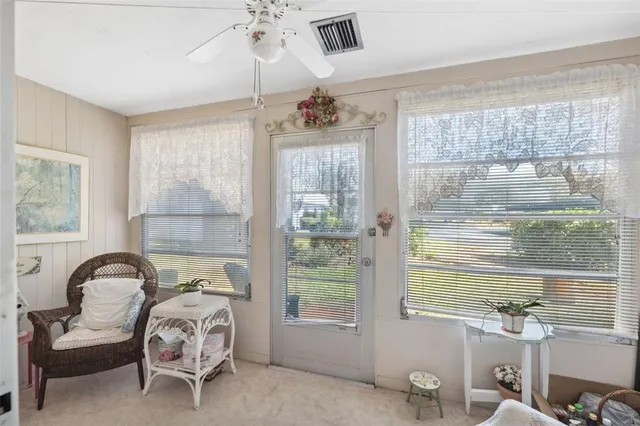 a bedroom with furniture and a large window
