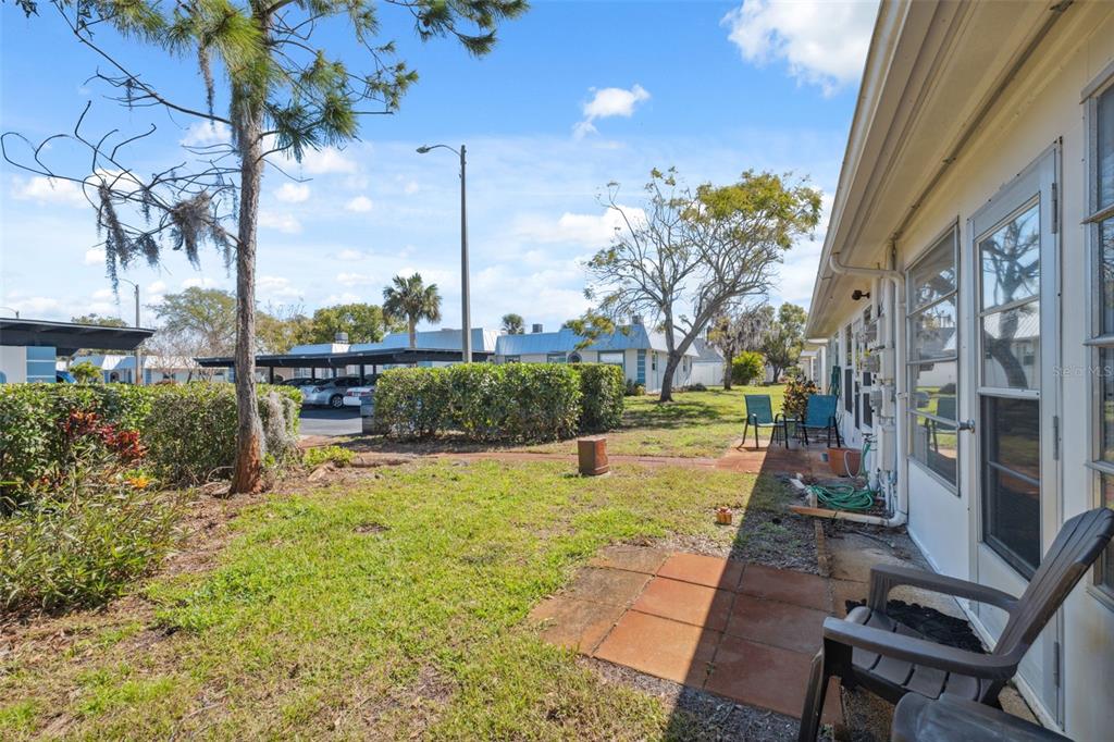 4222 Richmere Drive, Unit 4222 New Port Richey, FL 34652 - Photo 5 of 36 a view of a patio with table and chairs potted plants