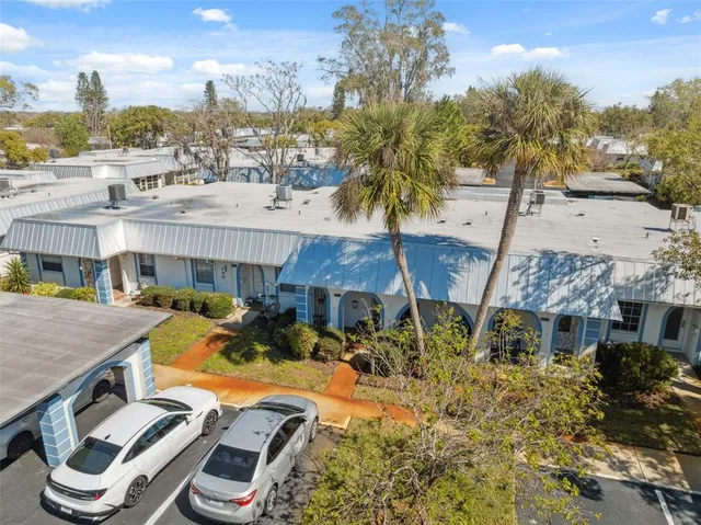 a front view of a house with garden and patio