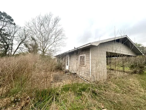 a backyard of a house with large trees