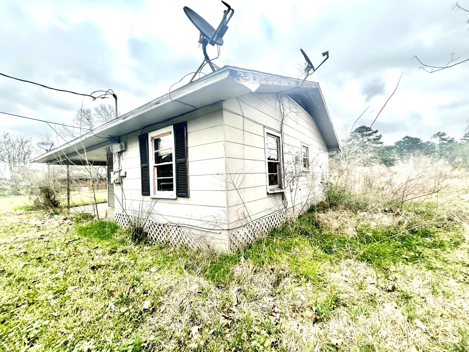 9122 Tulane Road Orange, TX 77630 - Photo 15 of 17 a view of a house with a small yard and wooden floor and fence