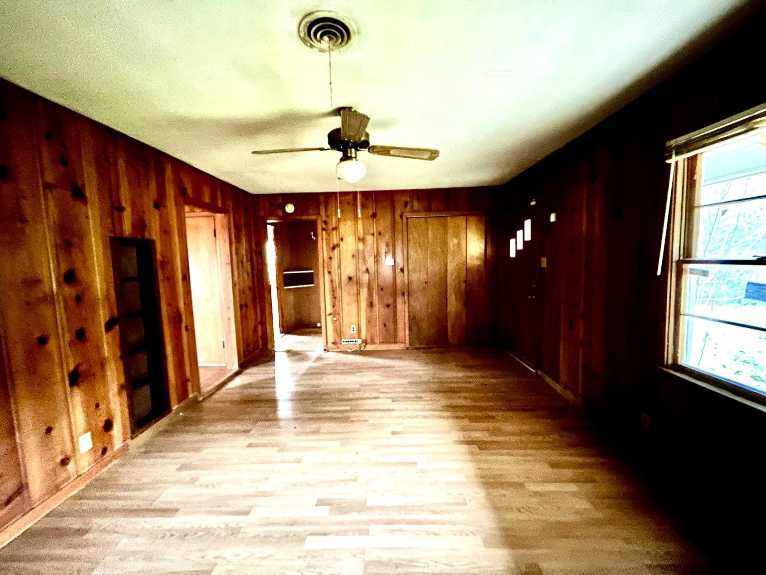 9122 Tulane Road Orange, TX 77630 - Photo 3 of 17 a view of an empty room with a window and a chandelier fan