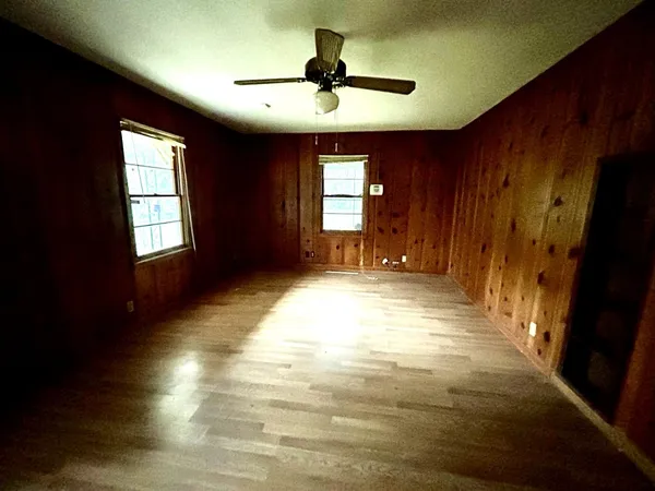 a view of empty room with window and hardwood floor