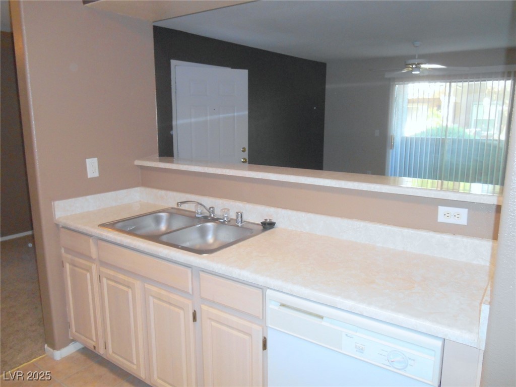 555 East Silverado Ranch Boulevard, Unit 1073 Las Vegas, NV 89183 - Photo 11 of 21 Kitchen with white dishwasher, light countertops, light tile patterned floors, and ceiling fan