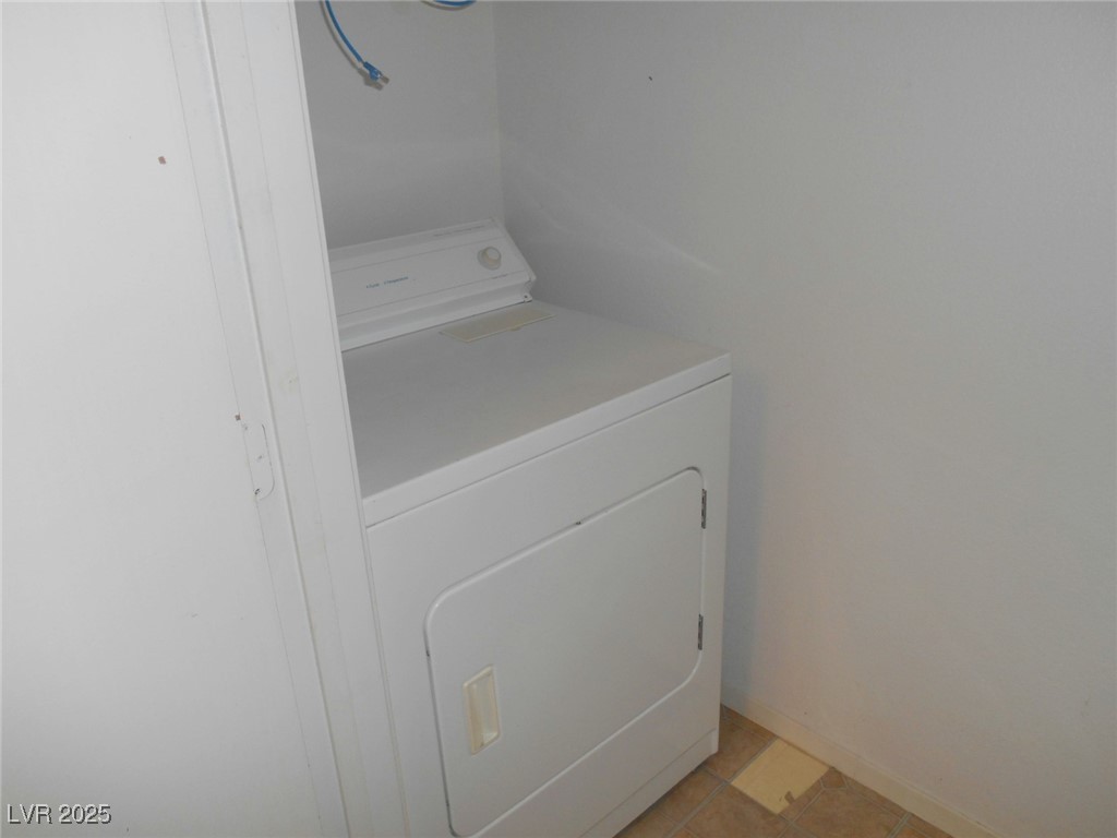 555 East Silverado Ranch Boulevard, Unit 1073 Las Vegas, NV 89183 - Photo 13 of 21 Laundry room featuring washer / dryer and baseboards