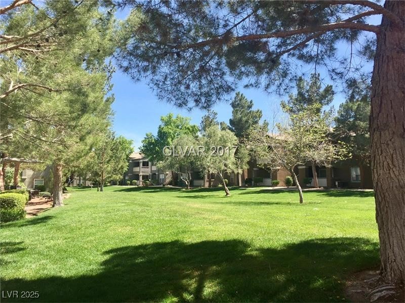 555 East Silverado Ranch Boulevard, Unit 1073 Las Vegas, NV 89183 - Photo 16 of 21 View of home's community featuring a yard