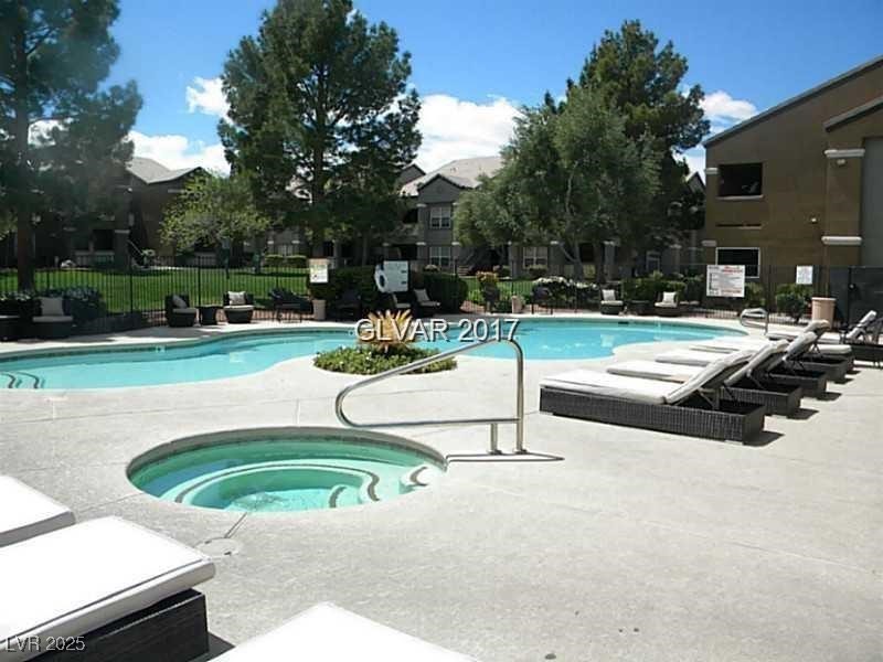 555 East Silverado Ranch Boulevard, Unit 1073 Las Vegas, NV 89183 - Photo 19 of 21 Community pool featuring a community hot tub and a patio
