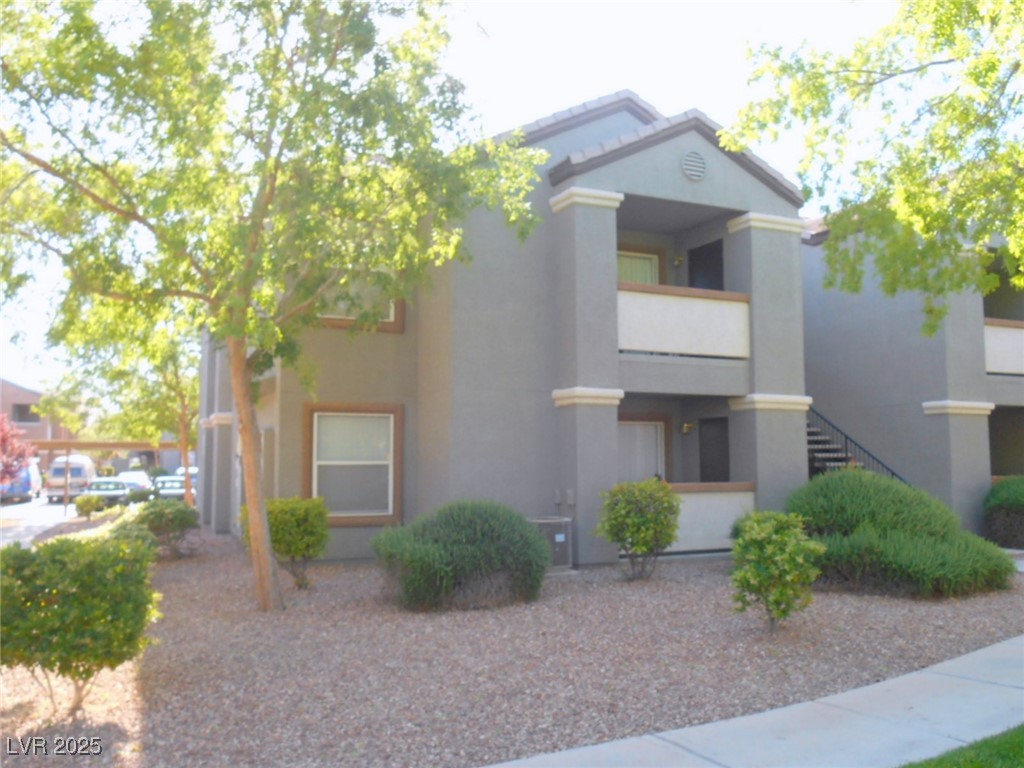 555 East Silverado Ranch Boulevard, Unit 1073 Las Vegas, NV 89183 - Photo 2 of 21 View of front of house featuring stucco siding and stairway