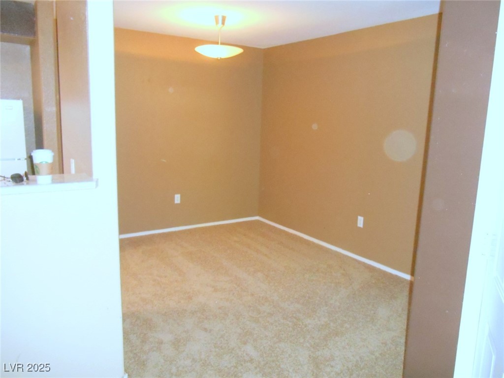 555 East Silverado Ranch Boulevard, Unit 1073 Las Vegas, NV 89183 - Photo 4 of 21 Carpeted empty room featuring baseboards
