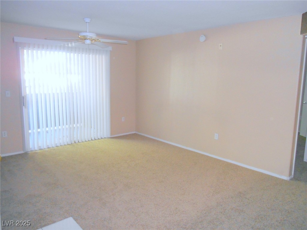 555 East Silverado Ranch Boulevard, Unit 1073 Las Vegas, NV 89183 - Photo 5 of 21 Spare room featuring carpet and ceiling fan