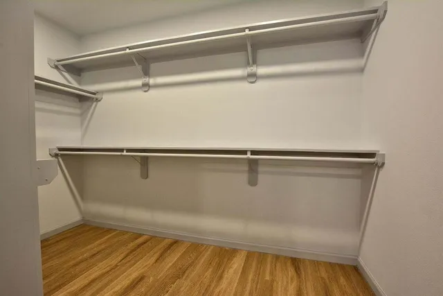 a view of a room with wooden floor