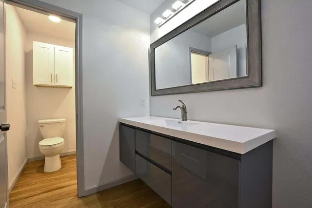 a bathroom with a toilet sink and mirror